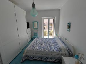a bedroom with a bed in a white room at Da Papi Johnny in Maratea +13 photos