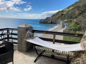 a hammock on a balcony overlooking the ocean at Melinda Tower in Plomari +15 photos