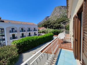 a balcony with a view of a building and mountains at Da Papi Johnny in Maratea