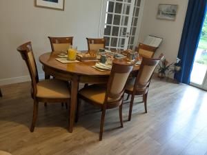 a wooden dining room table with chairs and a tableasteryasteryasteryasteryasteryastery at Foxgloves in La Motte +8 photos