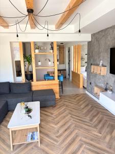 a living room with a couch and a table at Luna Apartman in Višegrad +21 photos