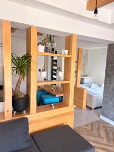 a living room with wooden shelves and a table at Luna Apartman in Višegrad