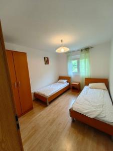 a bedroom with two beds and a window at Romantic auch mit Kindern in Sutomore +60 photos