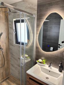 a bathroom with a sink and a mirror at Luna Apartman in Višegrad