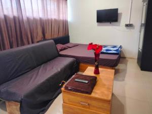 a living room with a couch and a table at Hotel Bluesky in Surat