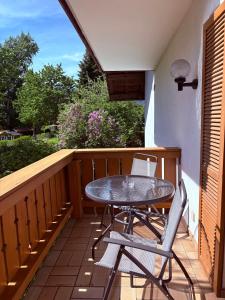 a table and two chairs on a balcony at Ferienwohnungen an der RupertusTherme in Bad Reichenhall