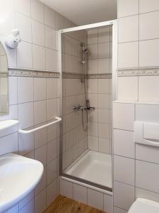 a shower with a glass door in a bathroom at Haus *Üüs Aran* Wohnung Nr. 6 in Nebel +25 photos