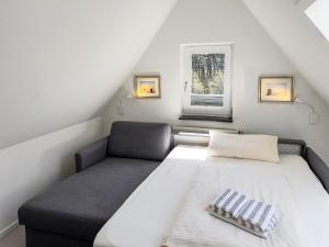 a small bedroom with a bed and a window at Haus *Üüs Aran* Wohnung Nr. 6 in Nebel