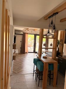 a kitchen and living room with a table and chairs at Luna Apartman in Višegrad
