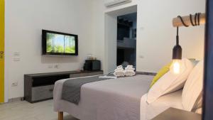 a bedroom with a bed and a flat screen tv at Urban & B in Civitavecchia