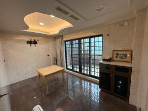 a large room with a table and a large window at 木木 Lin in Chiayi City