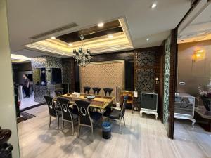 a dining room with a table and black chairs at 木木 Lin in Chiayi City