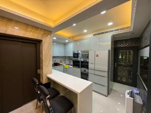 a kitchen with a white counter and some chairs at 木木 Lin in Chiayi City +3 photos