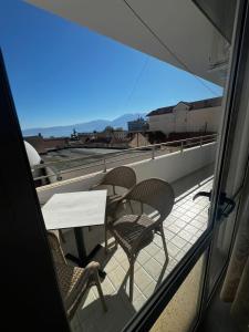 a table and chairs on a balcony with a view at InnPogradec Center in Pogradec +5 photos