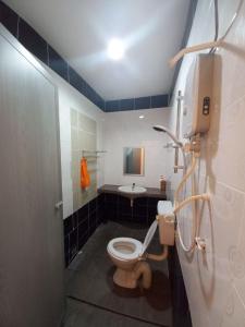 a bathroom with a toilet and a sink at mulia homestay in Teluk Intan +25 photos