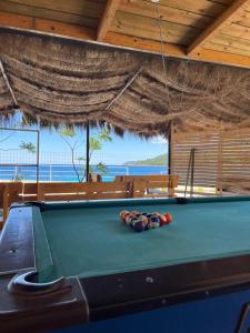 a pool table with four balls on top of it at Oasis on the Beach in Himare