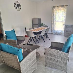 a living room with a table and chairs and a table at Oasis Mountain Retreat in Le Morne
