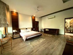 a large bedroom with a bed and a fireplace at Chinar Homes Amritsar in Amritsar