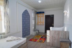 a living room with a bed and a table at XIVA AZIM OTA in Khiva +59 photos