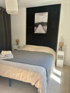a bedroom with a bed with a picture on the wall at U Sognu in Muro