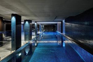 a swimming pool with blue lights in a building at Premium 2BR Braddon, Marriott Amenities in Braddon