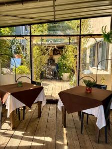 a patio with two tables and a screened in porch at U Sognu in Muro