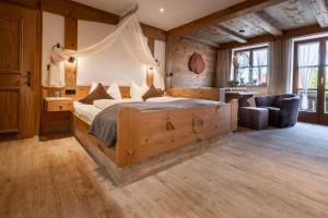 a bedroom with a large bed and a couch at Das Landhaus in Pfronten +170 photos