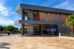 a building with a palm tree in front of it at Office Villas Costinesti in Costinesti