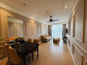a living room with a table and a couch at Bow Luxury 3 in Danang