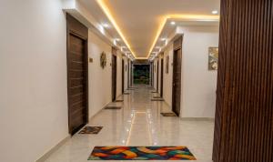 a hallway of a building with a rug on the floor at Hotel Sooryavanshi in Ayodhya