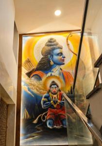 a large painting of a woman with a bow at Hotel Sooryavanshi in Ayodhya