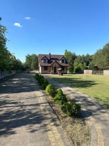 a house with a road leading to a house at Summer house near the forest in Dybki