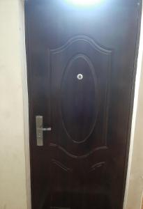 a black door with a handle in a room at Hotel MANTASHOV in Meghri