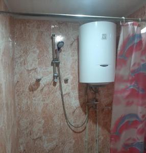 a shower in a bathroom with a water tank at Hotel MANTASHOV in Meghri