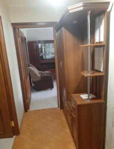 a hallway with a room with a chair and a mirror at Hotel MANTASHOV in Meghri