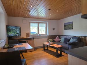 a living room with a couch and a table at Walser Auszeit in Riezlern