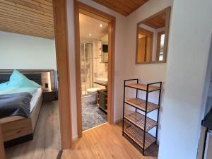 a small bedroom with a bed and a bathroom at Walser Auszeit in Riezlern