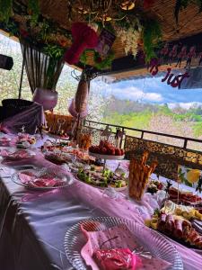 a table with food on it with a table cloth at Къща за гости Дени in Chukovezer
