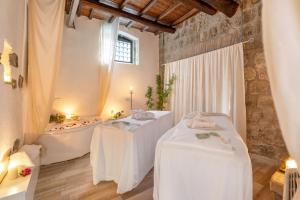 a bathroom with two tables and a bath tub at B&B dei Papi Boutique Hotel in Viterbo