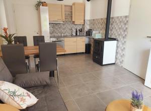 a kitchen with a table and a kitchen with a stove at Vidam in Csengőd