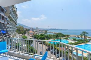 a balcony with a view of the pool and the ocean at Bay B Blu,Modern 1BR Chalet -Seaview in Ed Dkârîne
