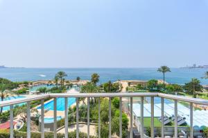 a view of the pool and ocean from the balcony of a resort at Bay B Blu,Modern 1BR Chalet -Seaview in Ed Dkârîne