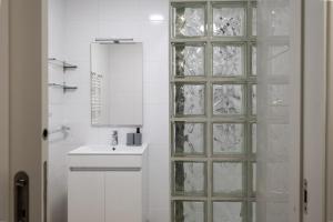 a bathroom with a glass shower door next to a sink at Villa Aurora in Livramento +40 photos