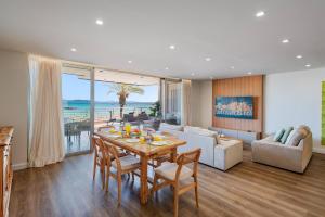 a living room with a table with chairs and a couch at Apartment VistaMar I in Port de Pollensa