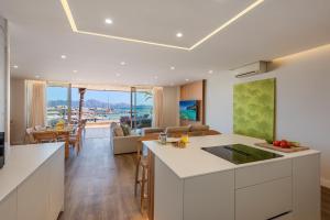 a kitchen and living room with a view of the ocean at Apartment VistaMar I in Port de Pollensa +9 photos