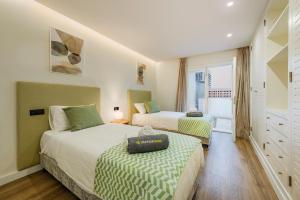 a bedroom with two beds and a window at Apartment VistaMar I in Port de Pollensa