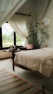 a bedroom with a bed with a table and a window at Neverland de Papillons in Sa Ðéc