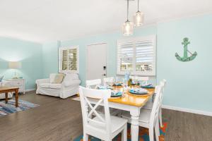 a dining room with a table and white chairs at Late August Labor Day Deals! Ocean Block Sleeps 6 Beach Gear in Ocean City