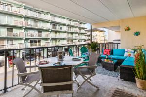 a balcony with a table and chairs and a couch at Late August Labor Day Deals! Ocean Block Sleeps 6 Beach Gear in Ocean City