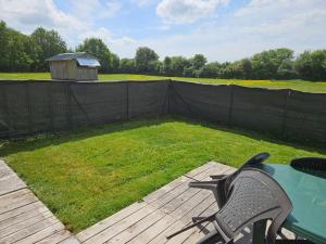 a patio with a table and chairs and a yard at Nid de Coucou in Cernoy-en-Berry